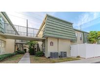 Building exterior showcasing walkway, landscaping, and building features at 1799 N Highland Ave # 28, Clearwater, FL 33755