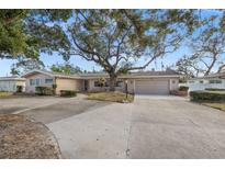 Single-story home with circular driveway and mature landscaping at 289 Rafael Ne Blvd, St Petersburg, FL 33704