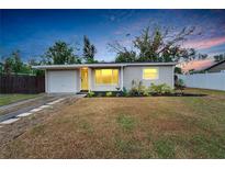 Charming single-story home with a well-manicured lawn, attached garage, and inviting curb appeal at 6524 14Th N St, St Petersburg, FL 33702