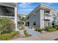 Inviting condo exterior with lush landscaping and a paved walkway at 6923 Stonesthrow N Cir # 4105, St Petersburg, FL 33710