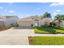One-story house with a two-car garage and landscaped lawn at 12518 Midpointe Dr, Riverview, FL 33578