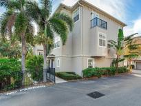 Townhouse with palm trees, shrubs, and a black fence at 2606 Espana Ct, Tampa, FL 33609