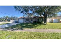 Charming single-story home with a well-maintained front lawn and attached garage at 6425 Rosewood Dr, Tampa, FL 33615