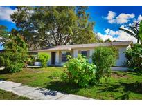 Charming single-story home featuring lush landscaping and a well-maintained front yard at 9567 85Th St, Seminole, FL 33777