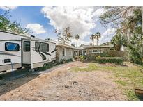 Front exterior view of a home with an RV parked on a paved driveway and landscaping at 307 10Th Ave, Indian Rocks Beach, FL 33785