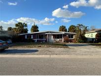 One-story home with a driveway and front yard at 415 86Th Ave, St Pete Beach, FL 33706