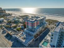Aerial view of a modern condominium building near the beach with partial ocean views at 15 Avalon St # 704, Clearwater Beach, FL 33767