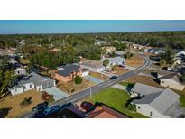 Aerial view of a residential neighborhood with houses and trees at 4401 Plumosa St, Spring Hill, FL 34607