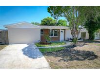 Charming single-story home with a brick facade and landscaped front yard at 8391 76Th Ave, Seminole, FL 33777