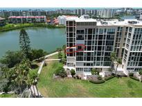 Luxury high-rise with a beautiful view of the water, manicured lawn, and mature palm trees in a desirable coastal location at 7400 Sun Island Dr # 501, South Pasadena, FL 33707