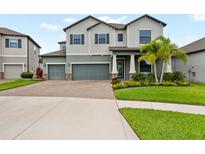 Attractive two-story home with a three-car garage and landscaped front yard at 13434 White Sapphire Rd, Riverview, FL 33579