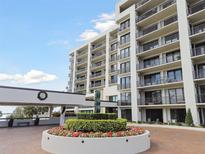 View of a modern condominium building with balconies, landscaping, and a decorative wreath at 4 Belleview Blvd # 801, Belleair, FL 33756