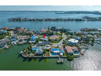 Aerial shot of waterfront property with a private dock and stunning bay views from this coastal community at 819 59Th Ave, St Pete Beach, FL 33706