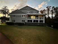 Two-story condo building with grey siding, balconies, and landscaping at 2533 Dolly Bay Dr # 101, Palm Harbor, FL 34684