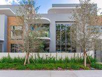 Modern two-story home with gray and wood siding, and a landscaped front yard at 3020 W Santiago St # 4, Tampa, FL 33629