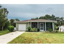 Charming single-story home with attached garage and screened porch at 4721 Fairway N Dr, Punta Gorda, FL 33982