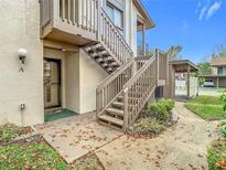 Exterior view of condo building showcasing stairs and entrance at 12914 Fairway Dr # A, Hudson, FL 34667