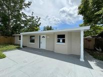 Renovated single-story home with a covered entryway and driveway at 5038 Galaxy Dr, New Port Richey, FL 34652