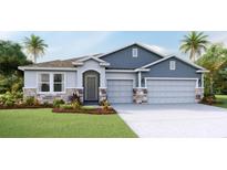 Charming two-story home with blue siding, stone accents, and a two-car garage at 16018 10Th E Ave, Bradenton, FL 34212