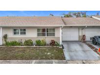 Front exterior view of a charming attached single-Gathering home with a one-car garage at 5316 Buttonwood Dr, New Port Richey, FL 34652