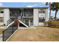 Exterior view of condo with stairs and landscaping at 1945 Pelican Landing Blvd # 616, Clearwater, FL 33762