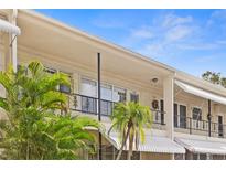 Attractive exterior of condo building with palm trees and balconies at 4143 56Th N St # 1003, Kenneth City, FL 33709