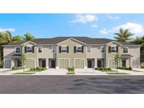 Exterior elevation of townhomes with garages, landscaping and palm trees at 1146 Great Ibis Dr, Ruskin, FL 33570