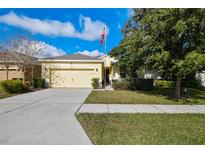 Single-story home with attached garage and landscaped lawn at 17766 Garsalaso Cir, Brooksville, FL 34604