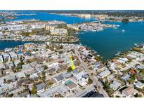 Aerial view of a charming house with a pool, situated in a waterfront neighborhood at 255 146Th Ave E, Madeira Beach, FL 33708