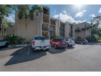 Exterior view of apartment building with ample parking at 90 S Highland Ave # 416, Tarpon Springs, FL 34689