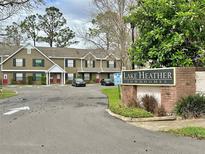 Lake Heather Townhomes street view with parking and community sign at 16543 Lake Brigadoon Cir, Tampa, FL 33618