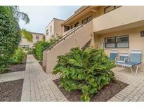 Exterior of property with walkway, stairway and seating at 4621 Gulf Of Mexico Dr # D10, Longboat Key, FL 34228