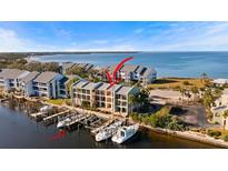 Aerial view of waterfront property with boat slips and private docks at 907 Bahia Del Sol Dr, Ruskin, FL 33570