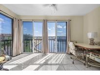 Bright sunroom with water views and sliding glass doors at 19029 Us Highway 19 N # 8-25, Clearwater, FL 33764