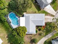 Aerial view showing house, pool, and landscaped yard at 1622 Whithorn Pl, Palm Harbor, FL 34684