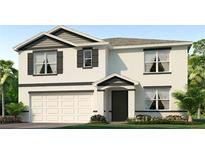Two-story house with white siding, dark gray accents, and a white garage door at 1281 Maritime Hammock Ave, Ruskin, FL 33570