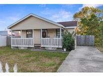 Charming yellow house with a porch and a small yard at 3436 51St N Ave, St Petersburg, FL 33714