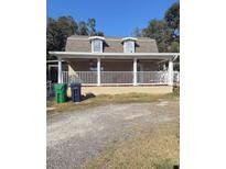House exterior featuring a covered porch and attractive landscaping at 4616 River Hills Dr, Tampa, FL 33617