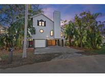 Two-story house with gray siding, a large window, and a two-car garage at 13182 72Nd Ter, Seminole, FL 33776