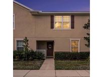 Well-maintained townhouse exterior with a walkway and landscaping at 5025 Cactus Needle Ln, Wesley Chapel, FL 33544