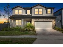 Two-story home with a neutral color palette and landscaping at 33157 Rosewood Bark Way, Wesley Chapel, FL 33545