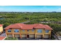 Aerial view of condo community showcasing building exteriors, landscaping, and boardwalk at 4327 Bayside Village Dr # 202, Tampa, FL 33615