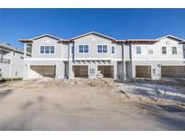 New construction townhome; three-unit building with attached garages at 5725 Desert Rose Pl, Tampa, FL 33615