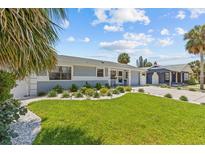 Charming single-story home with beautiful landscaping and a well-manicured lawn at 709 Mandalay Ave, Clearwater Beach, FL 33767