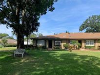 Cute condo with a manicured lawn and a large tree at 3259 Hilary Cir # 1A, Palm Harbor, FL 34684