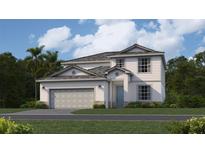 Two-story home with gray roof and light-colored siding, two-car garage, and landscaped yard at 10598 Buttercup Ct, Venice, FL 34293