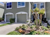 Two-car garage, well-maintained landscaping, and inviting front entrance at 10280 Post Harvest Dr, Riverview, FL 33578