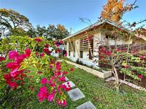 Charming mid-century home with colorful landscaping and walkway at 2666 44Th S St, Gulfport, FL 33711