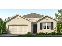 Single-story home with neutral siding, attractive landscaping, and a two-car garage at 35191 Valley Ridge Rd, Dade City, FL 33525