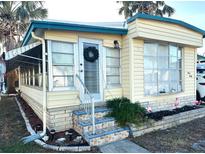 Inviting exterior of a manufactured home, featuring a landscaped yard and a charming entrance at 9790 66Th N St # 340, Pinellas Park, FL 33782